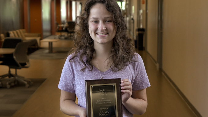 Emma Knabe pictured with the 2023 Kyle D. Mitchell Award Plaque