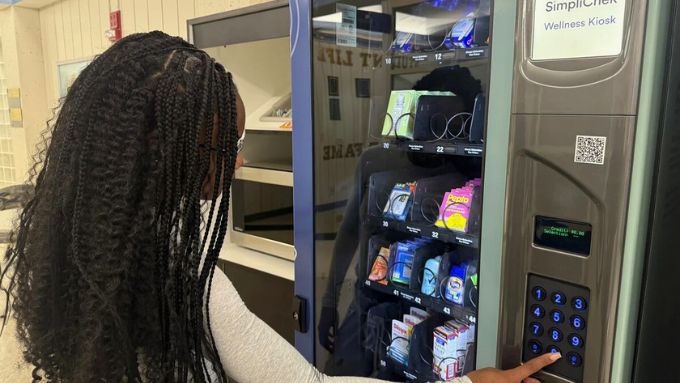 African American girl selecting an item from the Simplichek kiosk at RVC