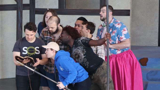 Cast of Something Rotten! rehearsing on stage at Starlight