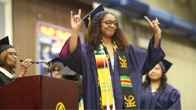 Jaden Newson at graduation, crossing the stage