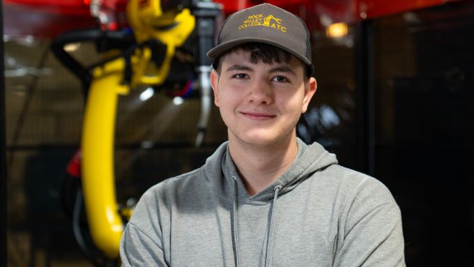 Seth Richardson standing in front of welding equipment