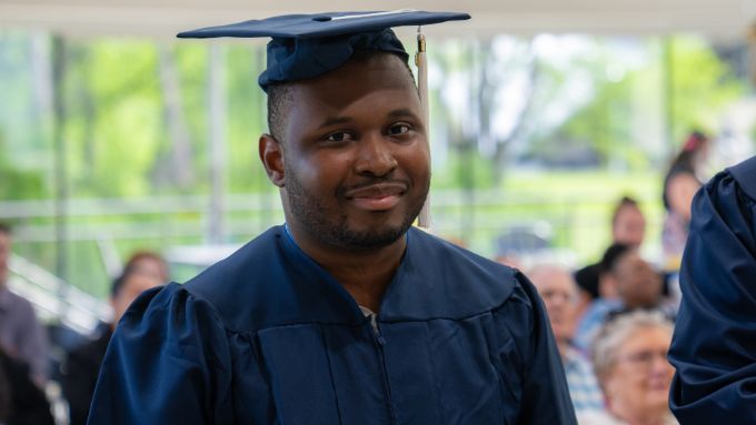 Student wearing cap and gown during RAISE ceremony