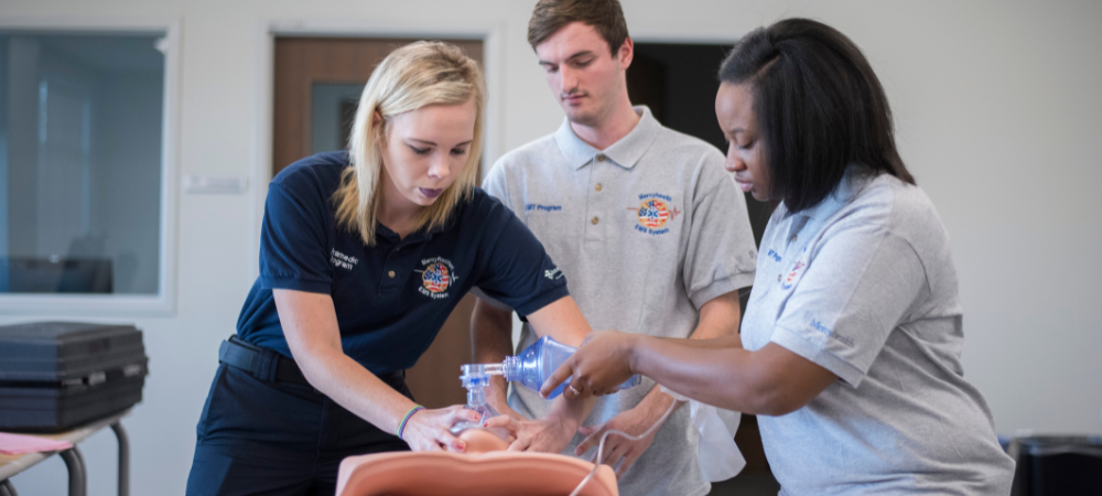 students practicing CPR skills on simulator